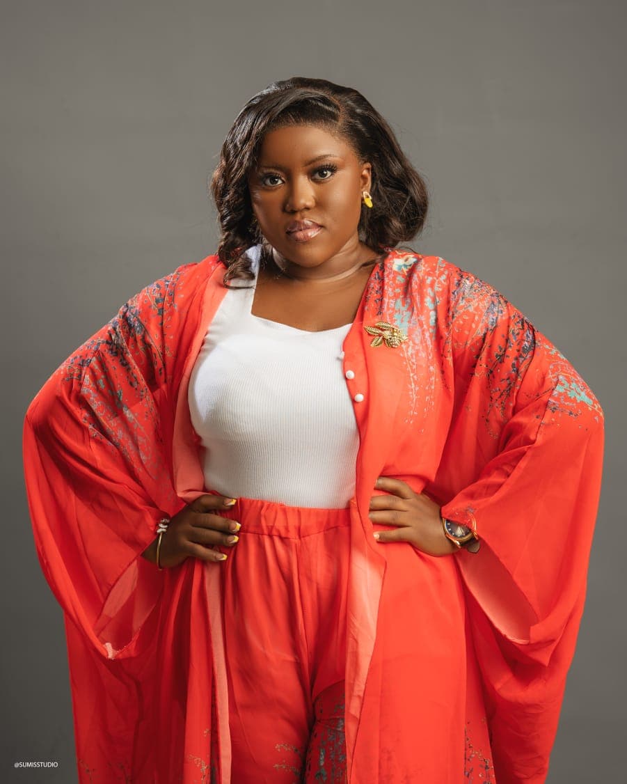A.J. Falone Ngu, hands on hips, in a red kimono.